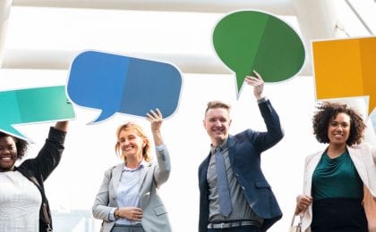 four people holding speech bubbles above their heads